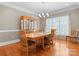 Classic dining room featuring hardwood floors, a large window and classic chandelier at 105 Walnut Hill Ct, Mooresville, NC 28115