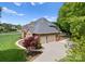 Exterior shot of the home with a three-car garage and beautifully landscaped yard at 105 Walnut Hill Ct, Mooresville, NC 28115