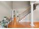 Bright foyer featuring hardwood flooring, staircase, and a view into the living area at 105 Walnut Hill Ct, Mooresville, NC 28115