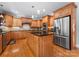 Spacious kitchen features custom wood cabinets, stainless steel appliances, and a center island at 105 Walnut Hill Ct, Mooresville, NC 28115