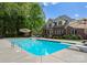 Inviting pool area with diving board, patio, and umbrella, perfect for outdoor relaxation at 105 Walnut Hill Ct, Mooresville, NC 28115