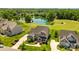 Aerial view of a beautiful brick home with a lush green lawn, long driveway, and a serene lake at 10517 Sable Cap Rd, Mint Hill, NC 28227