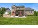 Spacious backyard featuring outdoor kitchen, patio seating, and a covered porch at 10517 Sable Cap Rd, Mint Hill, NC 28227