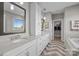 Bright bathroom featuring double sinks, modern fixtures, and a walk-in closet at 10517 Sable Cap Rd, Mint Hill, NC 28227