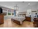 Comfortable bedroom with a large bed, hardwood floors, and natural light from the windows at 10517 Sable Cap Rd, Mint Hill, NC 28227