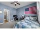 Comfortable bedroom with a blue accent wall, ceiling fan, and study area at 10517 Sable Cap Rd, Mint Hill, NC 28227