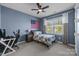 Cozy bedroom with a blue accent wall and a ceiling fan at 10517 Sable Cap Rd, Mint Hill, NC 28227