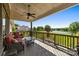 Covered deck overlooking a scenic lake and landscaped backyard at 10517 Sable Cap Rd, Mint Hill, NC 28227