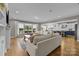 Bright living room with fireplace and open floor plan to the modern kitchen at 10517 Sable Cap Rd, Mint Hill, NC 28227