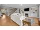 Open concept living room featuring hardwood floors, a fireplace, and staircase at 10517 Sable Cap Rd, Mint Hill, NC 28227