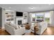 Bright living room with fireplace, built-in shelving, and view of the lake at 10517 Sable Cap Rd, Mint Hill, NC 28227