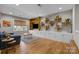 Open-concept living room with custom built-ins, shelving, and hardwood floors at 10517 Sable Cap Rd, Mint Hill, NC 28227