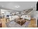 Spacious open-concept living room with hardwood floors and view into the kitchen at 10517 Sable Cap Rd, Mint Hill, NC 28227