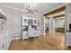 Spacious office area with wooden floors and built in shelving at 10517 Sable Cap Rd, Mint Hill, NC 28227