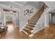 Staircase with wooden stairs, black iron balusters, and white risers at 10517 Sable Cap Rd, Mint Hill, NC 28227