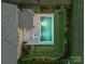 An aerial view of the backyard of this home shows an in-ground pool, manicured lawn, and patio seating area at 1107 Castle Rd, Indian Land, SC 29707