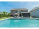 Beautiful pool with lounge chairs, a covered patio, and a spacious backyard at 1107 Castle Rd, Indian Land, SC 29707