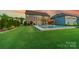 Expansive backyard with a well-maintained lawn and a luxurious in-ground pool, perfect for outdoor enjoyment at 1107 Castle Rd, Indian Land, SC 29707