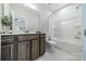Bathroom featuring a granite topped vanity, a large mirror and a tub with shower at 1107 Castle Rd, Indian Land, SC 29707