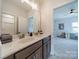 Bright bathroom featuring a double sink vanity with modern fixtures, and doorway to bedroom at 1107 Castle Rd, Indian Land, SC 29707