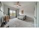 Cozy bedroom with carpet, a ceiling fan, large window with backyard view, and neutral decor at 1107 Castle Rd, Indian Land, SC 29707