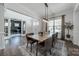 Bright dining room boasts hardwood floors, stylish lighting, a decorative rug and large window for natural light at 1107 Castle Rd, Indian Land, SC 29707