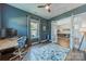A stylish home office with blue walls, natural light, and modern furnishings at 1107 Castle Rd, Indian Land, SC 29707