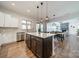 Spacious kitchen with stainless appliances, a center island, and seamless transition to the living and dining area at 1107 Castle Rd, Indian Land, SC 29707