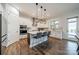 Bright kitchen features stainless steel appliances, a center island with seating, custom cabinets, and quartz countertops at 1107 Castle Rd, Indian Land, SC 29707