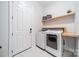 Clean laundry room featuring modern washer and dryer units, shelving, and a convenient layout at 1107 Castle Rd, Indian Land, SC 29707