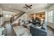 Open living room showcases hardwood floors, staircase, and is adjacent to the kitchen and dining areas at 1107 Castle Rd, Indian Land, SC 29707