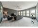 Spacious living room featuring modern furnishings, large windows offering ample natural light, and sleek design at 1107 Castle Rd, Indian Land, SC 29707