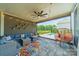 Inviting covered patio with comfortable seating, string lights, and a view of the pool and backyard at 1107 Castle Rd, Indian Land, SC 29707