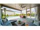Inviting covered patio with comfortable seating, string lights, and a view of the pool and backyard at 1107 Castle Rd, Indian Land, SC 29707
