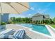 Backyard pool with lounge chairs, lush landscaping, and a view of the home's exterior at 1107 Castle Rd, Indian Land, SC 29707