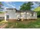 Exterior view of a house featuring a grassy backyard, accessible through a secure metal door at 1108 Old Dallas Hwy, Dallas, NC 28034