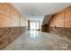 Unfinished basement featuring brick accents and a walk-out exit, offering potential for customization and expansion at 1108 Old Dallas Hwy, Dallas, NC 28034