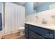 Bright bathroom featuring blue walls, white tile accents, and a vanity with a modern sink at 1108 Old Dallas Hwy, Dallas, NC 28034