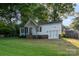 A charming single-story home featuring white siding, a brick foundation, and a lush green lawn at 1108 Old Dallas Hwy, Dallas, NC 28034