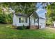 A single-story home with white siding, black shutters, brick foundation and a well-manicured lawn at 1108 Old Dallas Hwy, Dallas, NC 28034