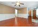 Spacious living room showcasing wood floors, wainscoting, neutral walls, and a ceiling fan at 1108 Old Dallas Hwy, Dallas, NC 28034