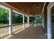 Inviting covered back porch with wood ceiling and flooring, offering a relaxing outdoor space at 116 S Broad St, Waxhaw, NC 28173