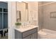 Bathroom featuring tiled shower over tub, gray vanity, white countertop, and stylish fixtures at 116 S Broad St, Waxhaw, NC 28173