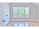 Bright bedroom with large window, a walk-in closet, and gleaming hardwood floors at 116 S Broad St, Waxhaw, NC 28173