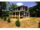 Beautiful two-story home featuring a large covered porch, manicured lawn, and mature trees at 116 S Broad St, Waxhaw, NC 28173