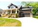 Beautiful craftsman-style home with a covered front porch, attached garage and a well-maintained lawn at 116 S Broad St, Waxhaw, NC 28173