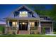 Charming craftsman-style home features a welcoming front porch with brick accents and manicured lawn at 116 S Broad St, Waxhaw, NC 28173