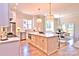 Bright open kitchen featuring a large center island, stainless appliances, and adjacent dining area at 116 S Broad St, Waxhaw, NC 28173