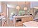 A stylish open kitchen with stainless steel appliances, a large island, and seamless flow to the dining and living areas at 116 S Broad St, Waxhaw, NC 28173