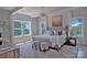 Bright main bedroom featuring large windows with natural light, neutral decor, and a stylish chandelier at 116 S Broad St, Waxhaw, NC 28173